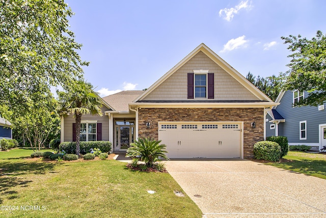 craftsman house featuring a garage and a front yard