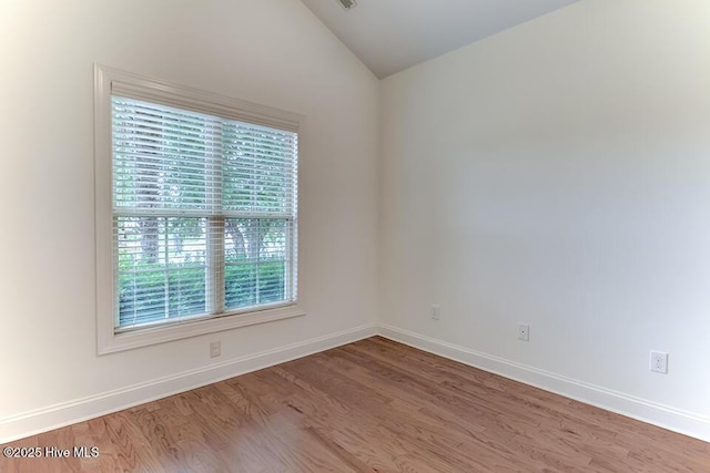 2173 Palm Pointe NE, Leland, NC 28451 - empty room with lofted ceiling, wood finished floors, and baseboards
