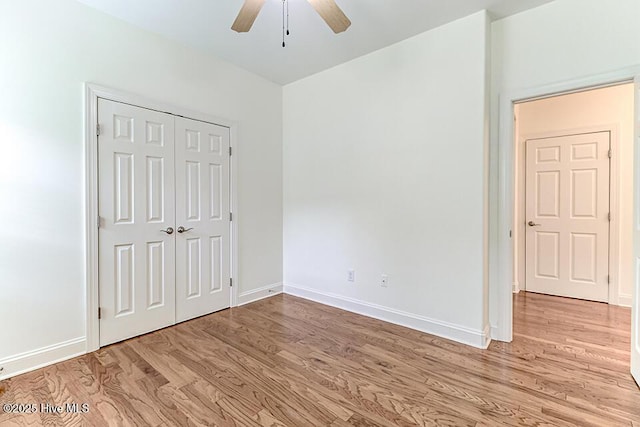 2173 Palm Pointe NE, Leland, NC 28451 - unfurnished bedroom with light wood finished floors, baseboards, a closet, and a ceiling fan