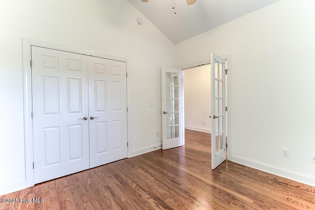 2173 Palm Pointe NE, Leland, NC 28451 - unfurnished bedroom with french doors, vaulted ceiling, wood finished floors, and baseboards