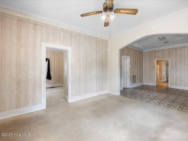 empty room with crown molding and ceiling fan