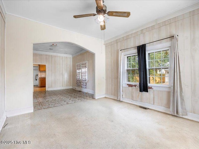 empty room featuring crown molding and ceiling fan