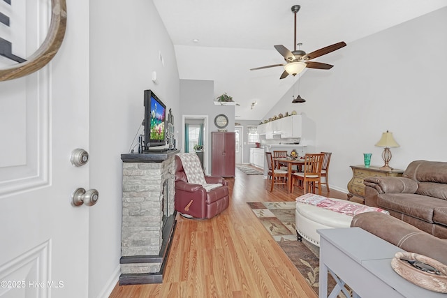 living room featuring hardwood / wood-style flooring, high vaulted ceiling, and ceiling fan