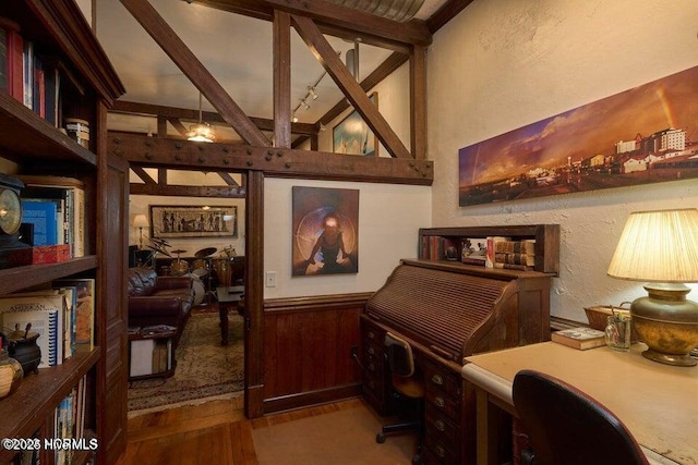 office area with beamed ceiling, hardwood / wood-style flooring, and wooden walls