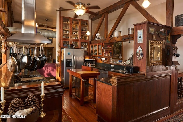 bar with island exhaust hood, lofted ceiling with beams, appliances with stainless steel finishes, dark hardwood / wood-style flooring, and ceiling fan