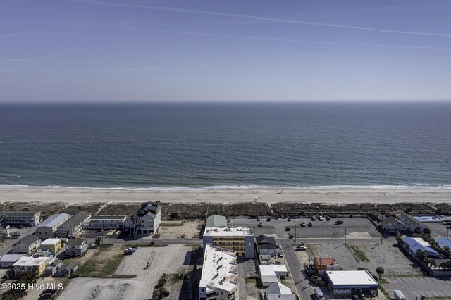 drone / aerial view featuring a water view and a beach view