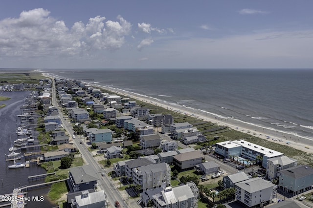 aerial view with a water view and a beach view