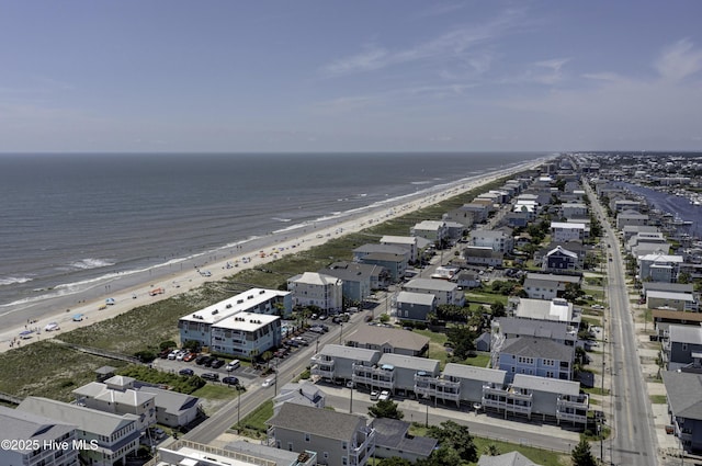 bird's eye view featuring a water view and a beach view