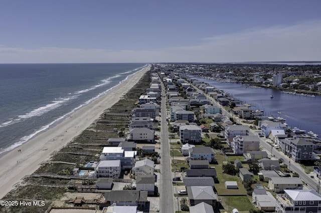 birds eye view of property with a view of the beach and a water view