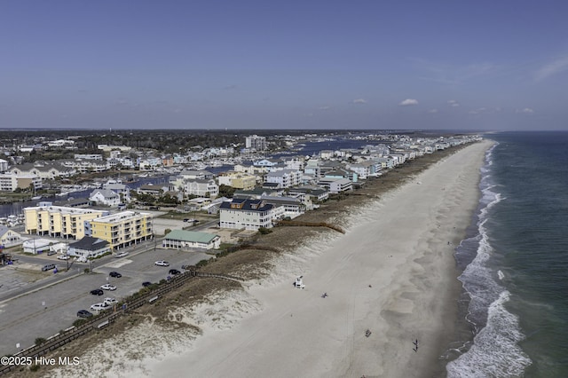 birds eye view of property featuring a beach view and a water view