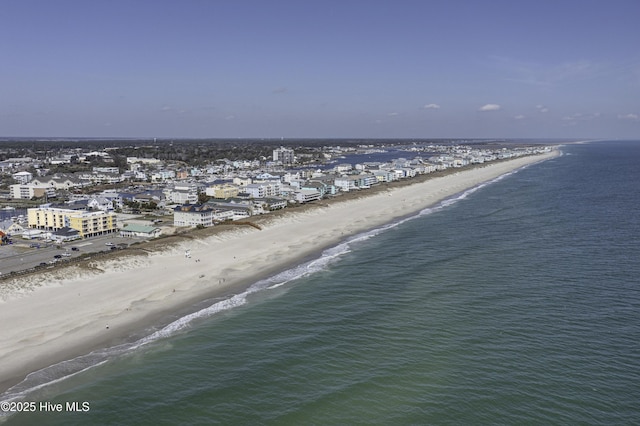 birds eye view of property with a water view and a beach view