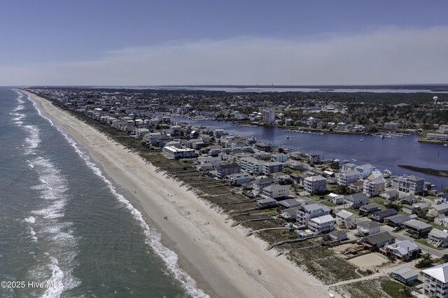 birds eye view of property with a water view and a beach view