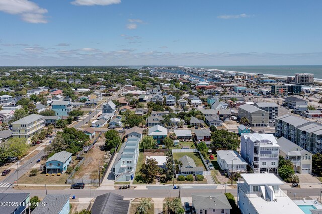 birds eye view of property featuring a water view and a beach view