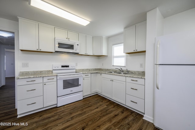 kitchen featuring sink, white cabinets, light stone counters, dark wood-type flooring, and white appliances