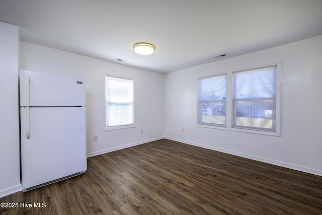 empty room featuring dark hardwood / wood-style flooring