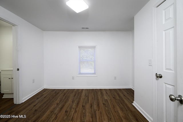 empty room with dark hardwood / wood-style floors