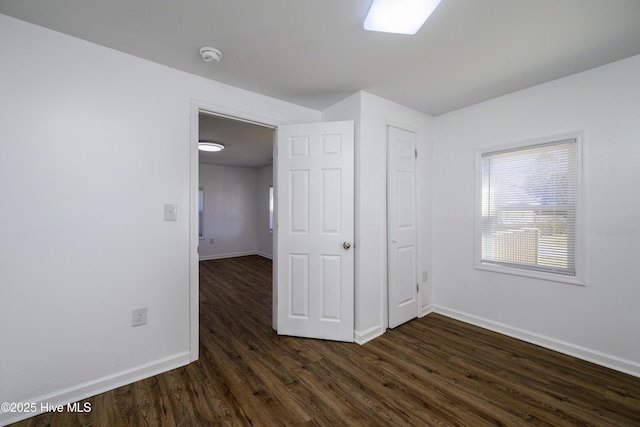 unfurnished bedroom featuring dark wood-type flooring