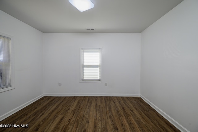 spare room featuring dark hardwood / wood-style floors