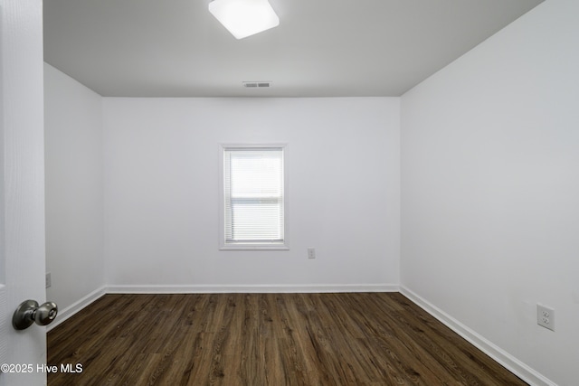 empty room featuring dark wood-type flooring