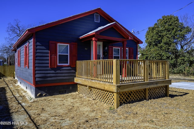 back of property featuring a wooden deck