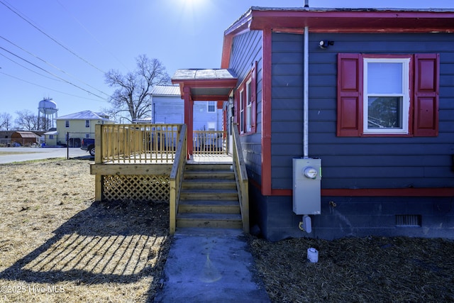 view of home's exterior with a wooden deck