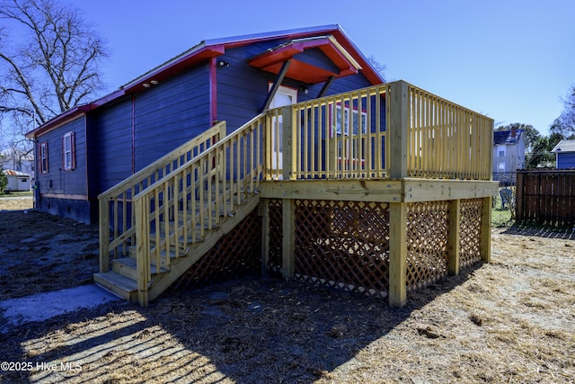 back of property with a wooden deck