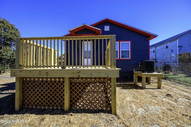 rear view of property with a wooden deck and central air condition unit