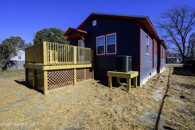 rear view of house featuring central AC and a deck