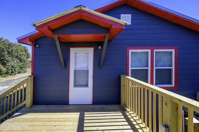 view of exterior entry featuring a deck