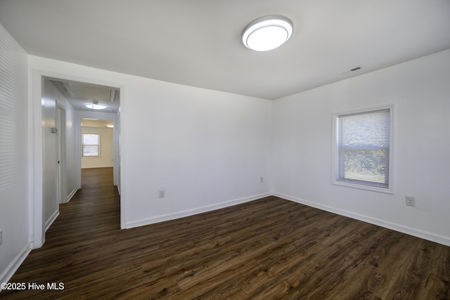 spare room with dark hardwood / wood-style flooring