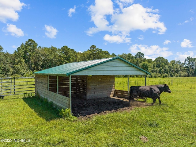 view of horse barn featuring a rural view