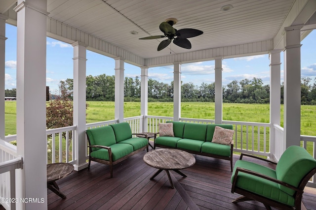 sunroom / solarium featuring ceiling fan