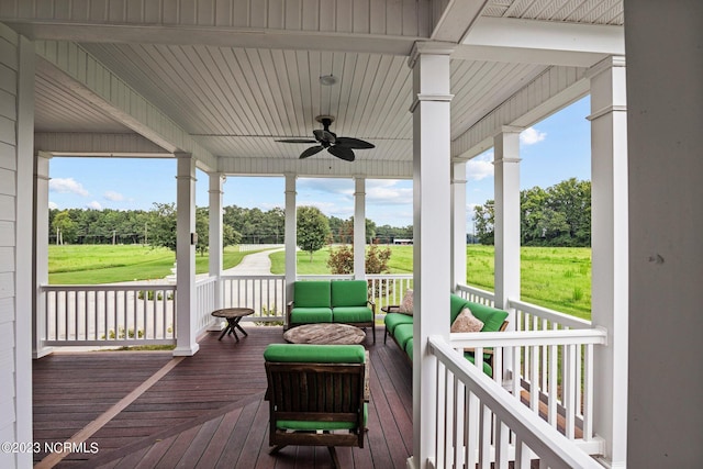 sunroom / solarium featuring a healthy amount of sunlight and ceiling fan