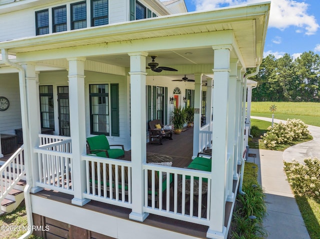 view of exterior entry with ceiling fan and covered porch