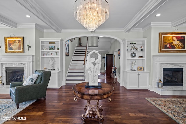 entrance foyer with dark wood-type flooring, ornamental molding, and a premium fireplace