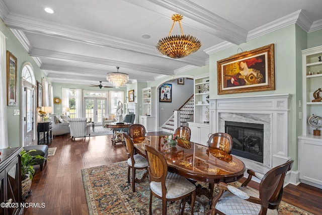 dining room with french doors, a high end fireplace, dark hardwood / wood-style flooring, and beamed ceiling