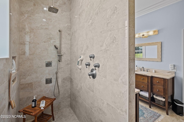 bathroom featuring vanity, ornamental molding, and a tile shower