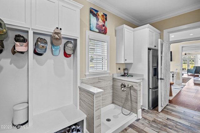 bathroom featuring hardwood / wood-style flooring and ornamental molding