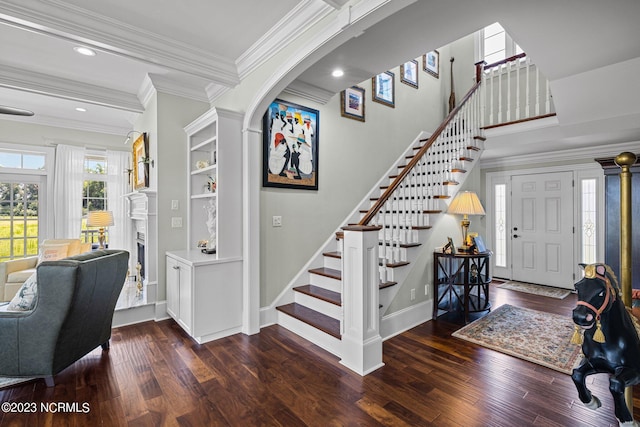 entrance foyer featuring ornamental molding and dark hardwood / wood-style flooring