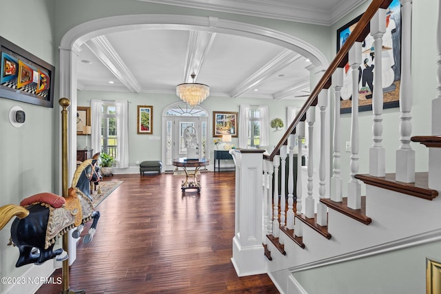 entryway featuring dark hardwood / wood-style flooring, beam ceiling, and ornamental molding