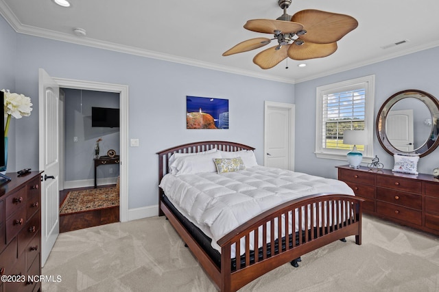 bedroom with ornamental molding, light colored carpet, and ceiling fan