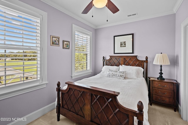 carpeted bedroom featuring ceiling fan and ornamental molding