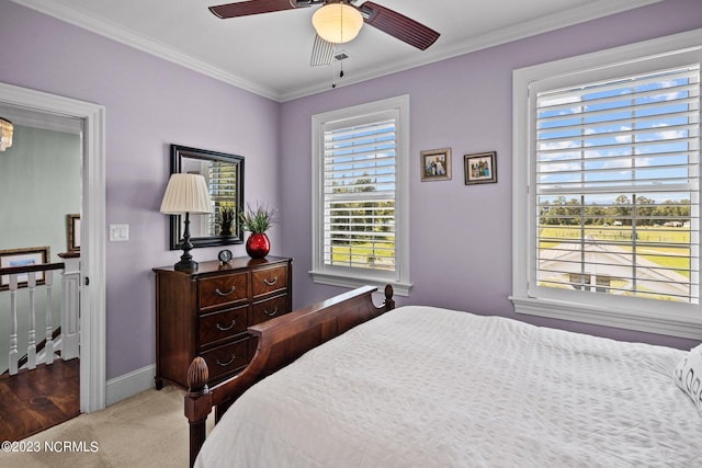 bedroom with ornamental molding, carpet floors, and ceiling fan