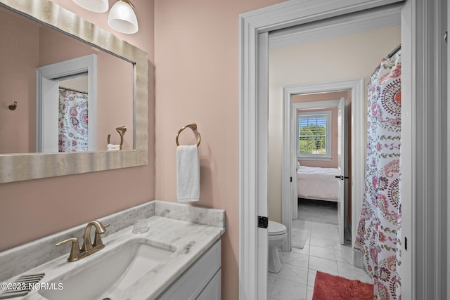 bathroom with tile patterned floors, vanity, and toilet