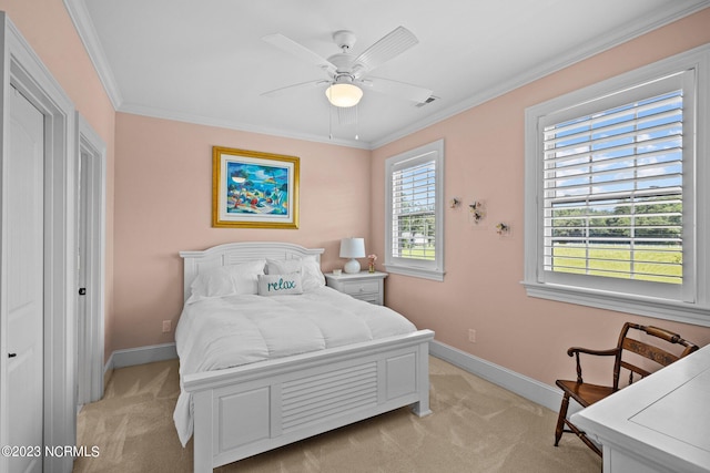 carpeted bedroom featuring crown molding and ceiling fan