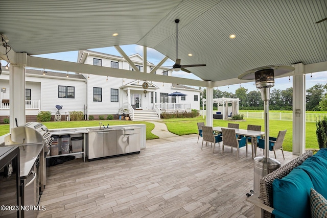 view of patio with area for grilling, outdoor lounge area, and ceiling fan