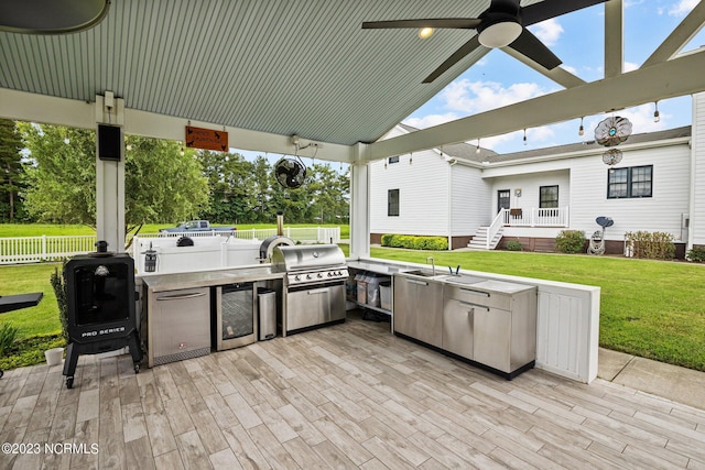 view of patio / terrace with sink, grilling area, ceiling fan, and exterior kitchen