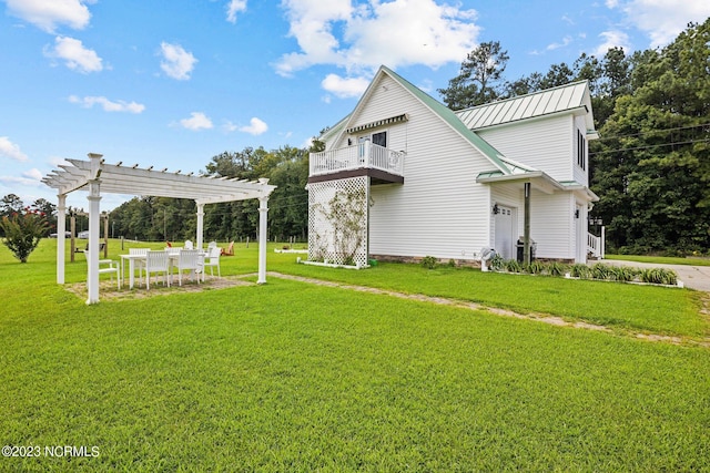 exterior space with a balcony, a pergola, and a front yard