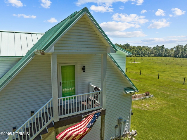 exterior space featuring a lawn and a rural view