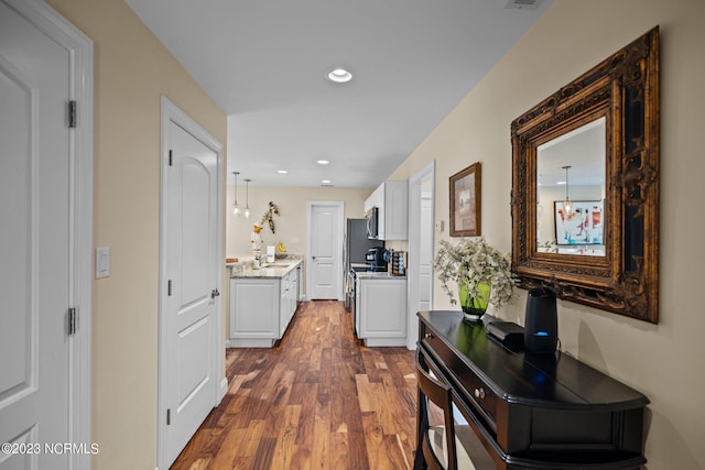 hallway with dark hardwood / wood-style floors